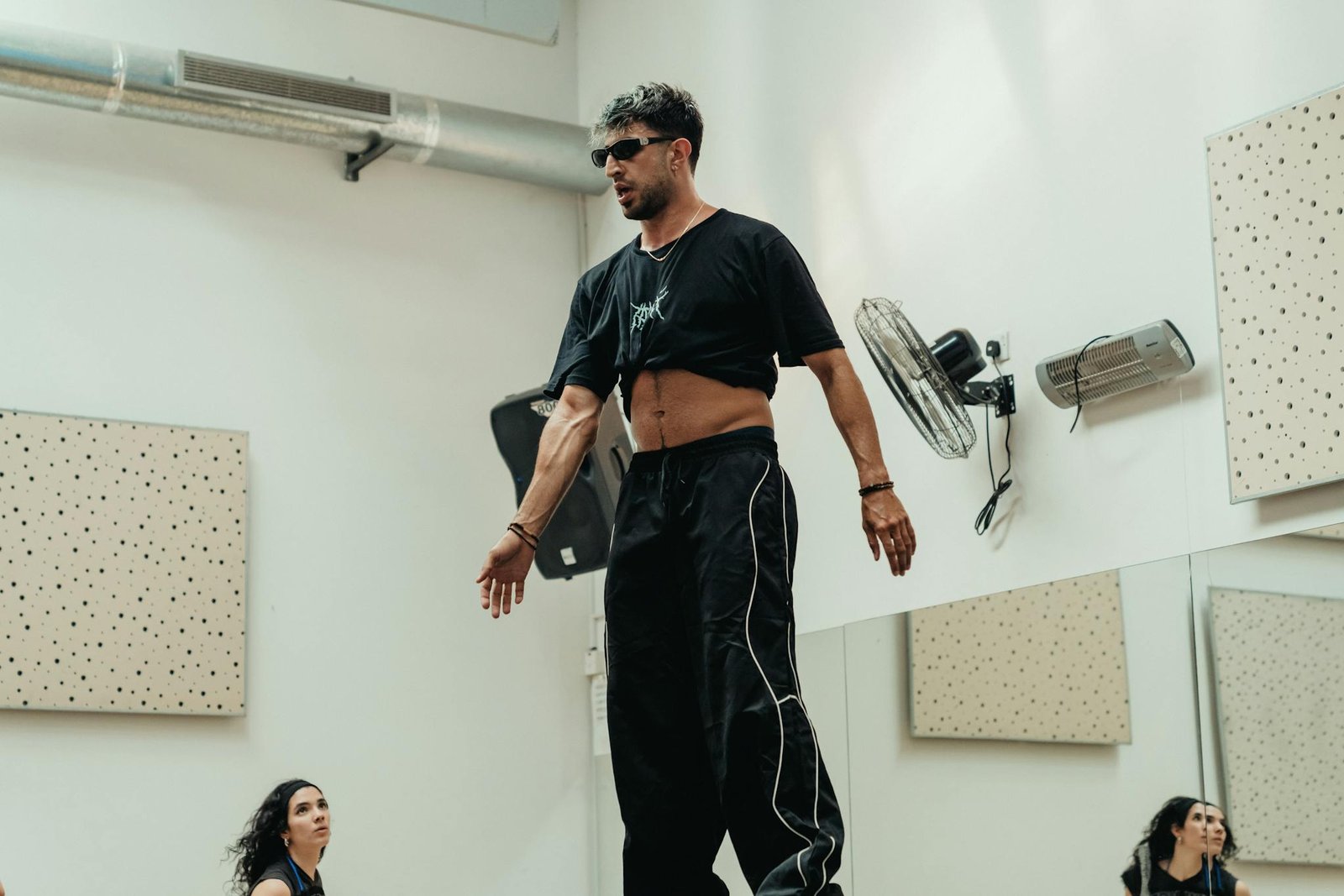 Dance instructor leading a class with enthusiasm in a well-lit studio setting.